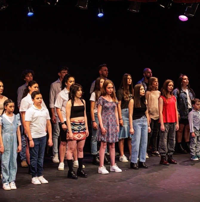 Students lined up on stage at a concert